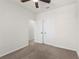 This bedroom features carpet, a ceiling fan and a large closet at 3214 Painted Blossom Ct, Lutz, FL 33558