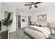 Bright bedroom with neutral carpet, modern decor, and access to an en-suite bathroom at 3214 Painted Blossom Ct, Lutz, FL 33558
