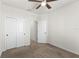 Bedroom with a ceiling fan, closet, carpet, and access to an en-suite bathroom at 3214 Painted Blossom Ct, Lutz, FL 33558