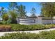 Stone community sign surrounded by lush landscaping and manicured shrubbery creates a welcoming entrance at 3214 Painted Blossom Ct, Lutz, FL 33558