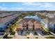 Beautiful exterior view of townhomes next to a lake with colorful facades and attached garages at 3214 Painted Blossom Ct, Lutz, FL 33558