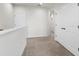 Well-lit hallway featuring neutral carpet and several white doors at 3214 Painted Blossom Ct, Lutz, FL 33558