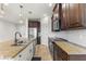 Spacious kitchen featuring a large island with a sink, granite countertops, and stainless steel appliances at 3214 Painted Blossom Ct, Lutz, FL 33558