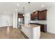 Bright kitchen with a central island, wooden floors, stainless steel appliances and shaker cabinets at 3214 Painted Blossom Ct, Lutz, FL 33558