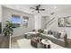 Bright living room with large windows, contemporary furniture, and a staircase at 3214 Painted Blossom Ct, Lutz, FL 33558