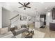 Open-concept living space with staircase, seamlessly connecting to the kitchen at 3214 Painted Blossom Ct, Lutz, FL 33558