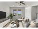 Well-lit living room with views from large windows, modern furniture and decor at 3214 Painted Blossom Ct, Lutz, FL 33558