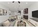 Modern open living space with a kitchen, contemporary furniture, and recessed lighting at 3214 Painted Blossom Ct, Lutz, FL 33558