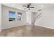Bright living area with tiled floors, stairs, and large windows that offer serene lake views at 3214 Painted Blossom Ct, Lutz, FL 33558