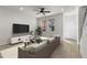 Modern living room featuring natural light, contemporary decor, and a staircase at 3214 Painted Blossom Ct, Lutz, FL 33558