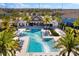 Relaxing pool view with lounge chairs, umbrellas, a cabana, and beautiful palm trees at 3214 Painted Blossom Ct, Lutz, FL 33558