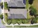 An aerial view of the property showcasing the roof, landscaping, driveway, sidewalk and surrounding neighborhood at 3822 Balcony Breeze Dr, Land O Lakes, FL 34638