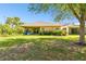 Cozy covered patio perfect for entertaining with sliding glass doors, backyard with trees, and comfy furniture at 3822 Balcony Breeze Dr, Land O Lakes, FL 34638