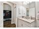 This bathroom features granite countertops, and tile floors that continue into the mudroom at 3822 Balcony Breeze Dr, Land O Lakes, FL 34638