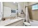Bright bathroom features tile surround, granite countertop, and neutral color palette at 3822 Balcony Breeze Dr, Land O Lakes, FL 34638