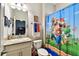 Playful bathroom features a fun shower curtain and granite countertops at 3822 Balcony Breeze Dr, Land O Lakes, FL 34638