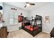 This carpeted bedroom features a ceiling fan, bunk beds, and window shutters at 3822 Balcony Breeze Dr, Land O Lakes, FL 34638