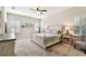 Cozy bedroom features a decorative ceiling fan, neutral decor, and natural light from shuttered windows at 3822 Balcony Breeze Dr, Land O Lakes, FL 34638