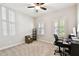 Bright bedroom with neutral carpet, two windows with shutters, and ceiling fan at 3822 Balcony Breeze Dr, Land O Lakes, FL 34638
