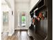 Bright entryway boasts wood-look tile flooring, an arched doorway and a stylish mudroom bench at 3822 Balcony Breeze Dr, Land O Lakes, FL 34638