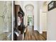 Inviting home entryway featuring wood-look tile flooring, arched doorways and a convenient mudroom bench at 3822 Balcony Breeze Dr, Land O Lakes, FL 34638