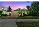 Beautiful single-Gathering home with brick driveway, manicured lawn, and stunning twilight sky backdrop at 3822 Balcony Breeze Dr, Land O Lakes, FL 34638