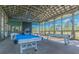 Brightly lit game room featuring ping pong and billiards under an architectural metal ceiling at 3822 Balcony Breeze Dr, Land O Lakes, FL 34638