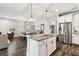Open-concept kitchen featuring a granite island, stainless steel appliances, and wood-look tile flooring at 3822 Balcony Breeze Dr, Land O Lakes, FL 34638