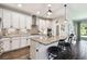 Modern kitchen with granite countertops, stainless steel appliances, and stylish white cabinetry at 3822 Balcony Breeze Dr, Land O Lakes, FL 34638
