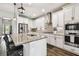 Bright kitchen with stainless steel appliances, white cabinets, granite countertops, and kitchen island at 3822 Balcony Breeze Dr, Land O Lakes, FL 34638