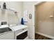 Laundry room featuring modern machines, wire shelf, and wood-look tile flooring at 3822 Balcony Breeze Dr, Land O Lakes, FL 34638