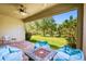 A covered patio with brick pavers, fire pit, ceiling fan, and peaceful backyard views at 3822 Balcony Breeze Dr, Land O Lakes, FL 34638