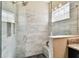 Glass enclosed shower features gray tile and pebble flooring, and a built-in bench at 3822 Balcony Breeze Dr, Land O Lakes, FL 34638