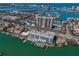 Aerial view showing the building's location near the waterfront, marina, and city skyline at 415 Island Way # 205, Clearwater Beach, FL 33767