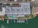 Aerial view of condo building with a boat dock and community pool at 415 Island Way # 205, Clearwater Beach, FL 33767