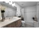 A bright bathroom with a quartz countertop and a view of the shower-tub combo at 415 Island Way # 205, Clearwater Beach, FL 33767