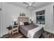 Well-lit bedroom featuring a queen bed, wood-look floors, white walls, a ceiling fan and a great view at 415 Island Way # 205, Clearwater Beach, FL 33767