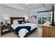 Bright bedroom features modern furnishings and a beautiful water view from the window at 415 Island Way # 205, Clearwater Beach, FL 33767