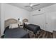 Bright bedroom features two beds, wood-look floors, a ceiling fan, closet, and white walls at 415 Island Way # 205, Clearwater Beach, FL 33767