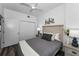 Cozy bedroom with wood-look floors, a queen bed, and white walls, creating a serene and restful atmosphere at 415 Island Way # 205, Clearwater Beach, FL 33767