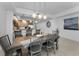 Dining room featuring a large wooden table with unique pendant lighting and an open view to the kitchen at 415 Island Way # 205, Clearwater Beach, FL 33767