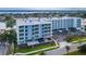 Modern condo complex featuring private patios, covered parking, and lush landscaping at 415 Island Way # 205, Clearwater Beach, FL 33767