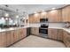 Contemporary kitchen featuring quartz countertops, stainless appliances, and wood cabinets at 415 Island Way # 205, Clearwater Beach, FL 33767