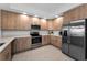 Modern kitchen with stainless steel appliances, ample wood cabinets, and light countertops at 415 Island Way # 205, Clearwater Beach, FL 33767