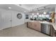 Open-concept kitchen with a breakfast bar, stainless steel appliances, and pendant lighting at 415 Island Way # 205, Clearwater Beach, FL 33767