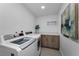 The laundry room features a modern washer and dryer, sleek cabinets, and a stylish quartz countertop at 415 Island Way # 205, Clearwater Beach, FL 33767