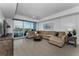 Spacious living room features stylish furniture, a ceiling fan, and water views at 415 Island Way # 205, Clearwater Beach, FL 33767