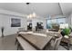 Bright living room with hardwood floors, a dining table, and large windows with a view of the intercoastal at 415 Island Way # 205, Clearwater Beach, FL 33767