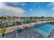 Beautiful community pool area with lounge chairs overlooking the waterfront and boat docks at 415 Island Way # 205, Clearwater Beach, FL 33767