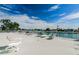 Roof deck with lounge chairs and tables with a view of the water at 415 Island Way # 205, Clearwater Beach, FL 33767